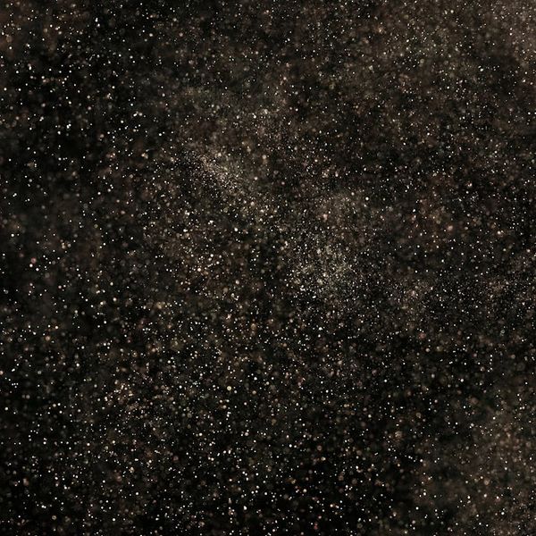 Silhouette of a person meditating against a cosmic background with cyan nebulae.